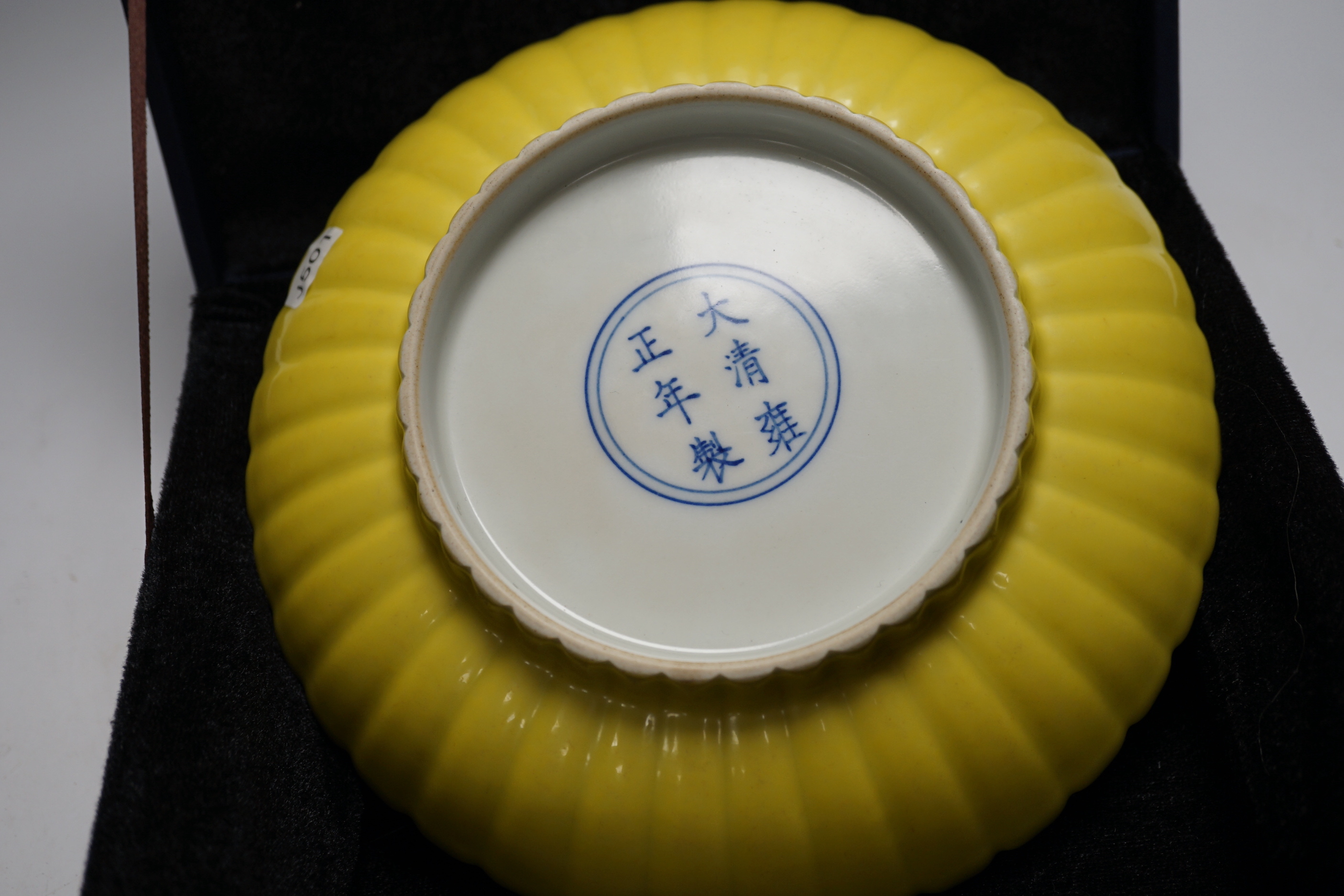 A Chinese yellow-ground fluted dish, housed in a fitted case, 20cm in diameter